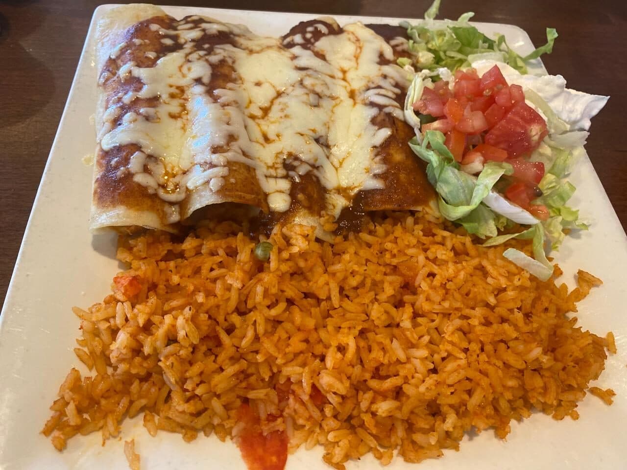 Enchiladas with melted cheese and Mexican rice
