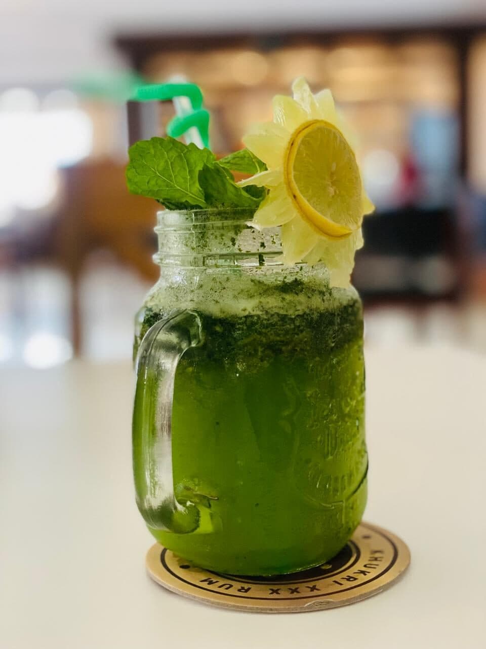 Mint lemonade in a jar with lemon and fresh mint