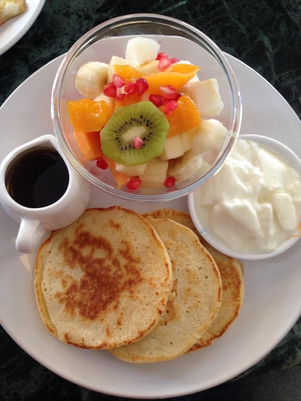 Pancakes with fruit salad, fresh curd and syrup