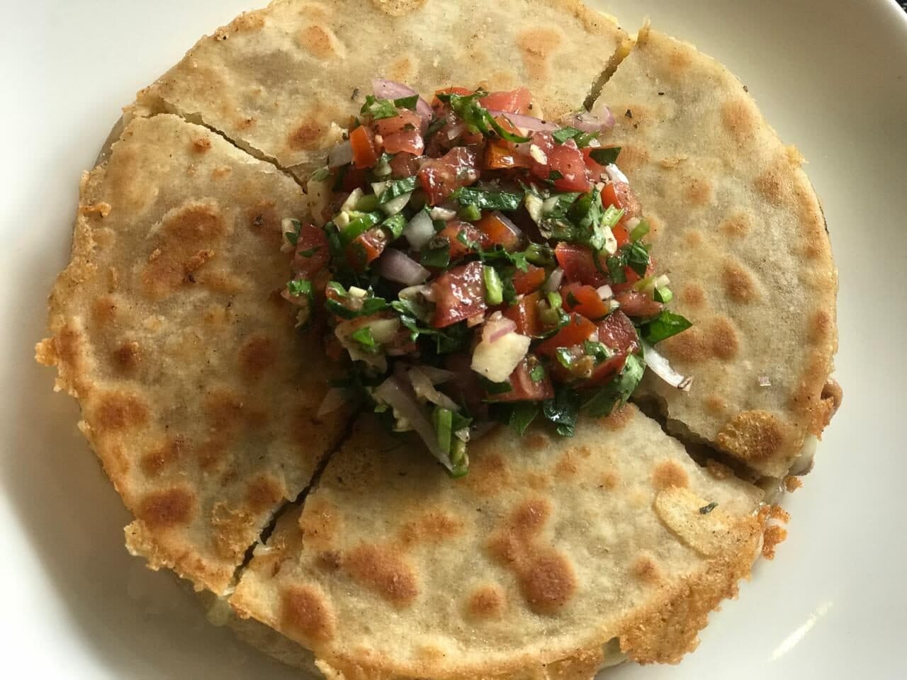 Quesadilla topped with fresh pico de gallo