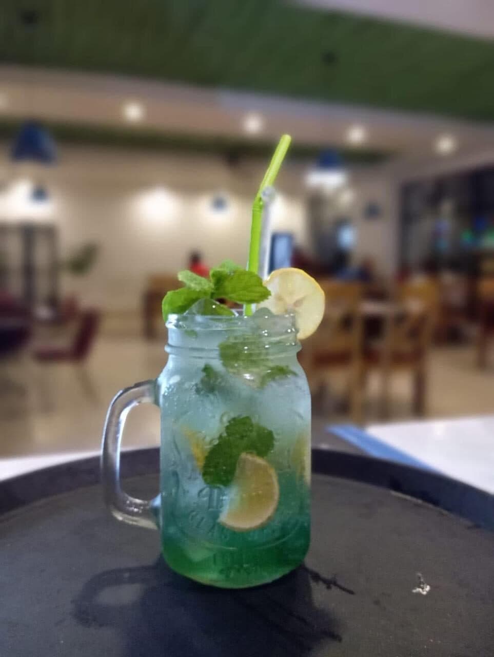 Blue mojito in a jar with mint and lemon