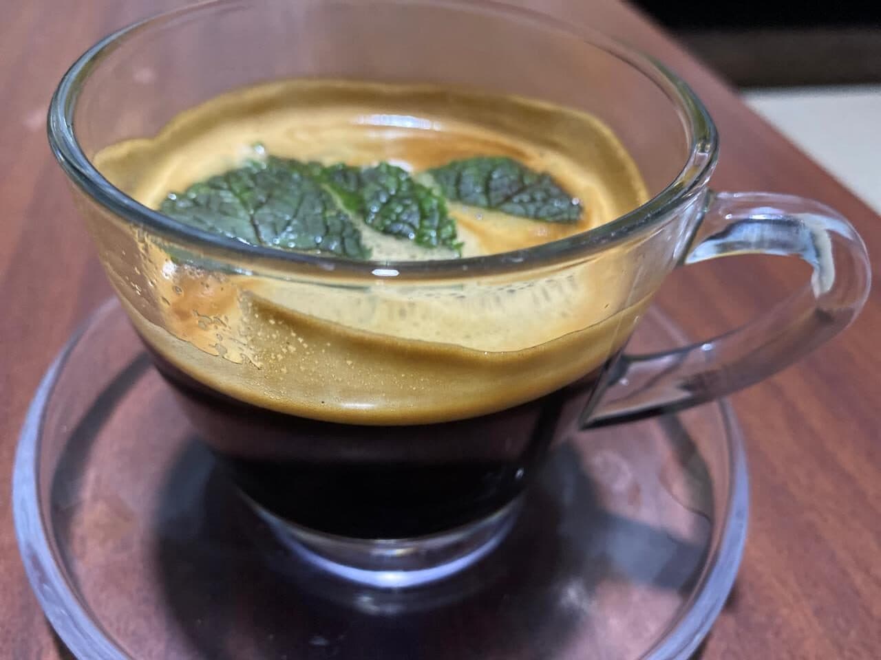 Espresso topped with mint leaves