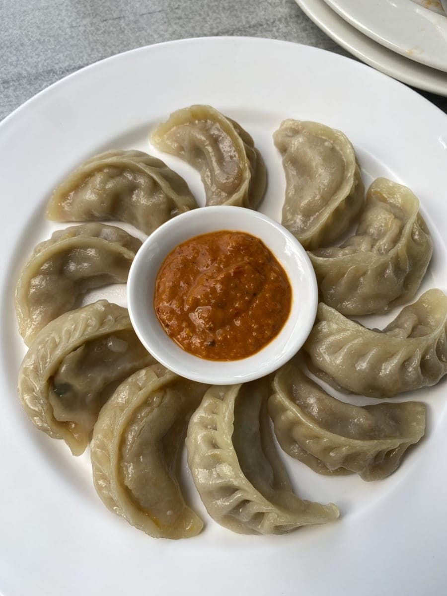 Steamed momo with tomato achar